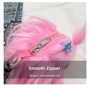 Detail view of smooth silver metal zipper on pink fuzzy monster plush crossbody bag