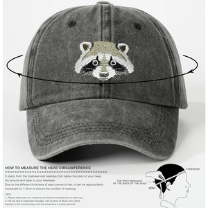 Gray washed cotton baseball cap featuring embroidered raccoon design and sizing guide
