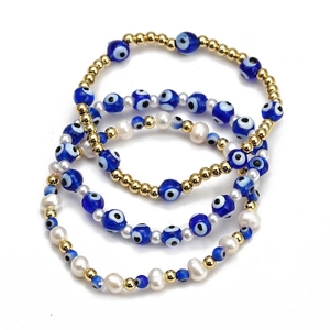 Detailed view of bohemian blue evil eye bead bracelet set with gold beads and pearls