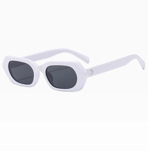 Detail of white vintage hexagonal sunglasses featuring silver studs and dark lenses