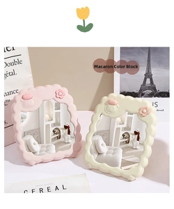 Detail of cute wavy desktop mirrors in pink and beige with embossed animal decor