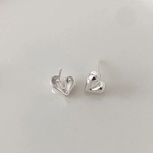 Macro shot of silver heart stud earrings with 925 sterling silver back post details