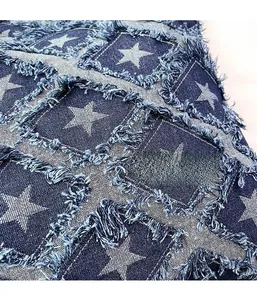 Detail of star pattern and frayed edge textures on premium denim checkered tote bag