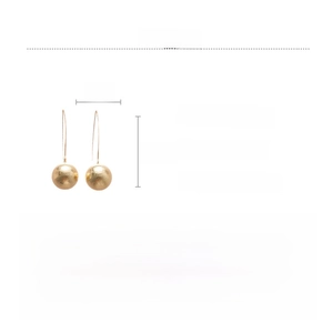 Detail view of gold finish copper drop earrings with frosted spheres and 6.5cm long hooks
