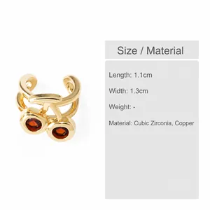 Close-up of cherry-shaped ear cuff with red cubic zirconia and 18k gold plating