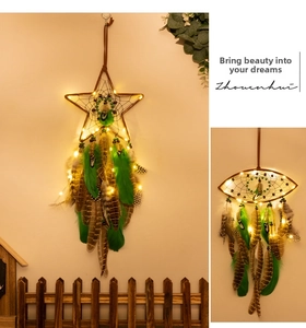 Detail of dream catcher with warm LED lights, natural feathers and handmade weaving