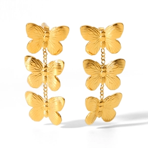 Detailed view of three-tier golden butterfly drop earrings with textured wings on white background