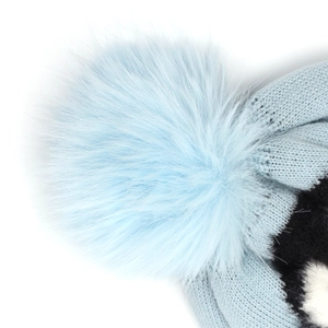 Close-up of soft light blue faux fur pompom and knitted texture on winter beanie hat