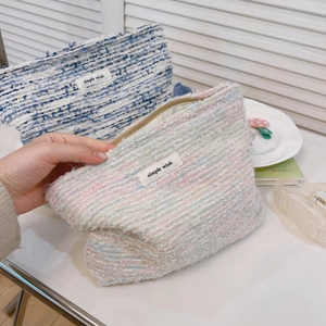 Tweed cosmetic bag in blue and pink weave with zipper closure and simple wish label