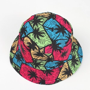 Detailed top view of the colorful tropical palm tree pattern on the reversible sun bucket hat