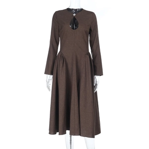 Detail of dark brown long sleeve dress with teardrop cutout and pleated waist