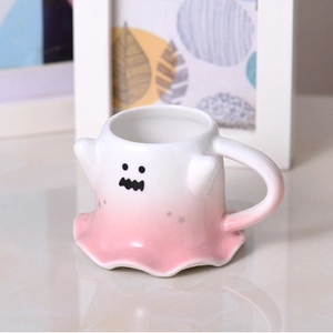Close-up of cute ghost ceramic mug with pink gradient finish and star details