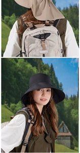 Detail view of wide brim sun hat with neck protection and hiking backpack in the forest