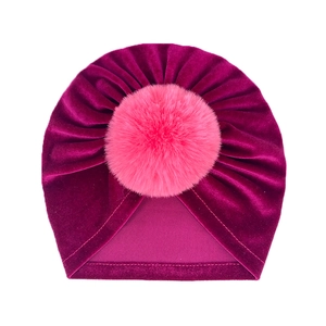 Velvet baby warm hat in plum purple with a large pink fluffy faux fur pompom detail