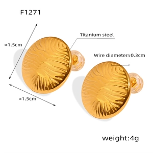 Detailed close-up of golden titanium steel earrings with wavy texture and dimensions
