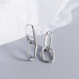 Detailed view of minimalist S925 silver oval interlocking link earrings with high polish