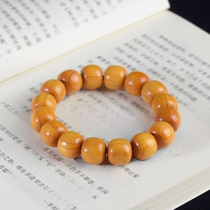 Detailed shot of New Mountain Sandalwood beads on an open book for zen aesthetic