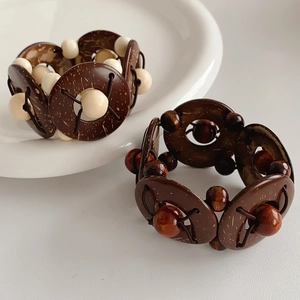 Macro view of geometric coconut shell and wood bead elastic bracelet with vintage ethnic style