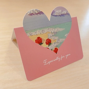 Detail of a 3D oil painting greeting card featuring a heart cutout with beach scenery