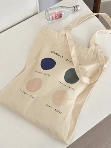 Minimalist canvas tote bag with Colour Palette print and double handles on white desk