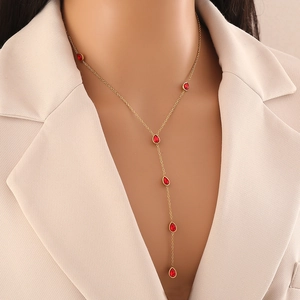 Y-shaped stainless steel necklace with red glass teardrop pendant on model