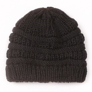 Detail shot of black knitted baby beanie showing thick ribbed texture for winter warmth