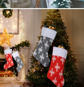 Detail of plush Christmas stockings with snowflake patterns hung by the warm fireplace