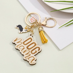 Detail of wooden Dog Mama keychain with corgi charm, paw print and yellow tassel
