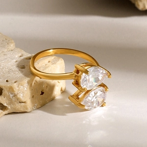 Macro shot of gold stainless steel open ring featuring two pear-shaped cubic zirconia stones