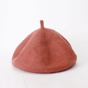 Close-up of the soft coral pink wool felt texture on a vintage style beret hat