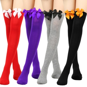 Detail of thigh high socks with satin bows in red, purple, grey, and black colors