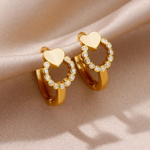 Macro shot of 18K gold plated heart earrings with pavé set cubic zirconia on silk