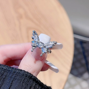 Silver Y2K butterfly open ring with sparkling zircon stones in a close-up handheld shot