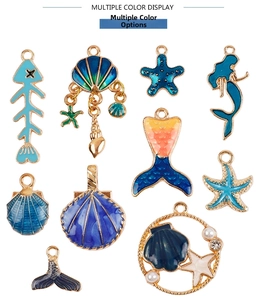 Detailed close-up of blue ocean-themed alloy charms with starfish and mermaid shapes
