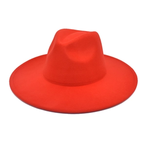 Detail view of the deep red fedora hat with a wide brim and classic indented crown structure