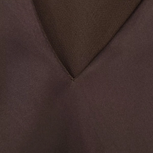 Detailed close-up of the V-neck seam and dark brown satin texture of the dress