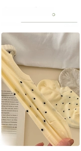 Close-up of low-cut polka dot socks with high-elastic ribbed cuffs in a soft cotton blend