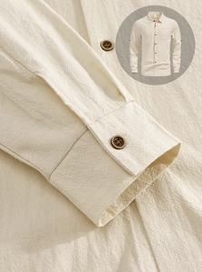 Detail of beige linen shirt showing fabric texture, retro buttons, and stand-up collar