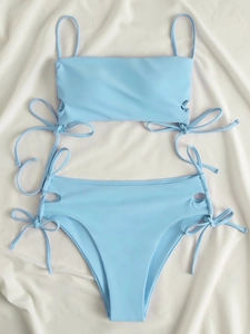 Flat lay of light blue two-piece bikini with side hollow out drawstring details