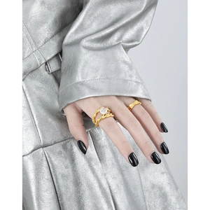Double-layered gold twist ring with baroque pearl on a model's hand in style