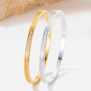 Polished stainless steel ribbed bracelets with inlaid zircons in gold and silver finish
