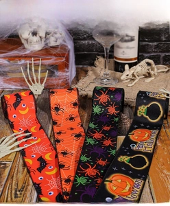 Detailed view of Halloween ribbons with spider and pumpkin patterns on dark background