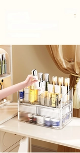 Detail view of transparent acrylic makeup organizer with tiered drawers for skincare storage