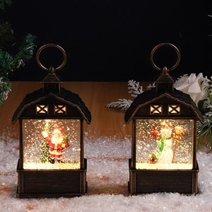 Detail of Christmas lantern with Santa and snowman motifs, led light and swirling glitter