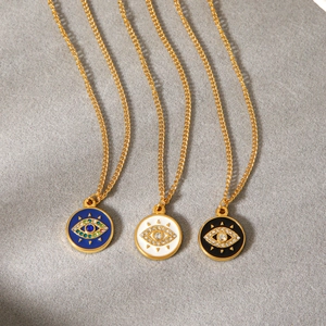 Three gold evil eye necklaces with blue white and black enamel and sparkling crystals