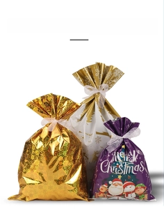 Three-pack festive Christmas gift bags with gold stars, reindeer, and ribbon ties