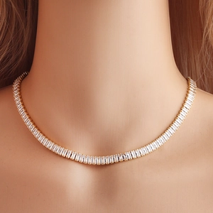 Elegant gold choker necklace with clear rectangular zircons worn on a model's neck