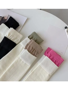 Close-up of ribbed knit texture on multi-colored high socks in a stylish flat lay