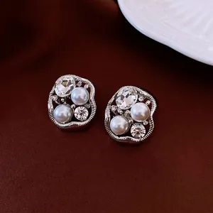 Vintage irregular oval pearl and crystal stud earrings with silver-textured metal frame