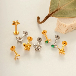 Titanium butterfly and star piercing studs in gold and silver finish with zircons